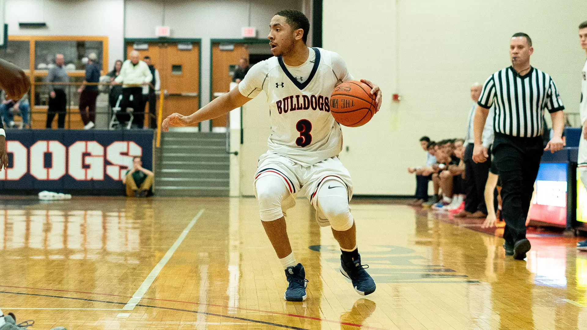 Ben Pratt dribbles in a white Bulldogs jersey during an SCBL youth basketball game in an indoor gym in the Lehigh Valley.