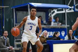 During an SCBL youth basketball game, Deandre Tillett dribbles in a white Generals uniform as coaches and spectators watch from the sidelines.