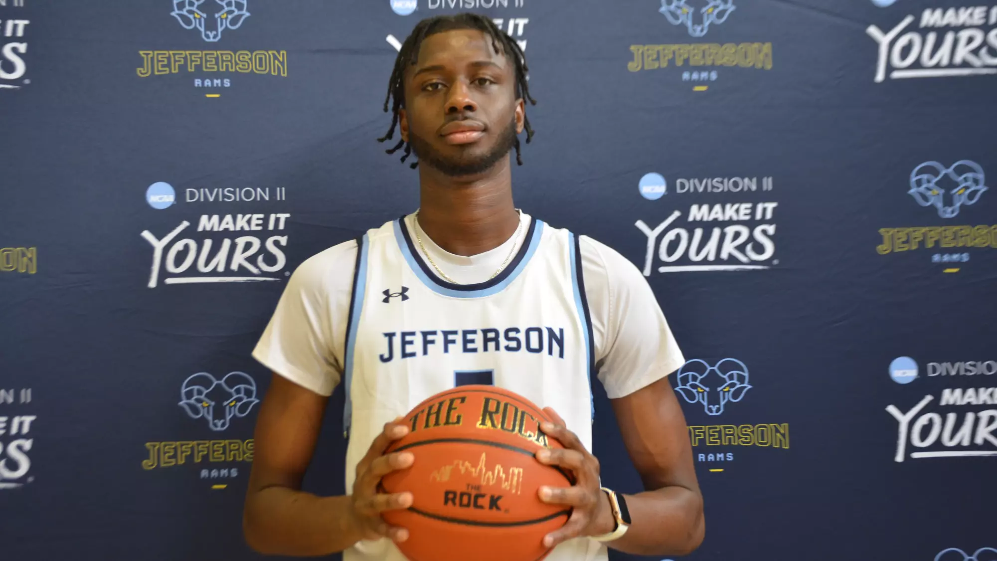 Moustapha Sanoh holds a basketball in a Jefferson Rams jersey, reflecting SCBL youth basketball development and competition across the Lehigh Valley.