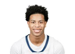 Adam Clark smiles in a white basketball jersey for SCBL youth basketball, reflecting development, competition, and community in Lehigh Valley since 2010.